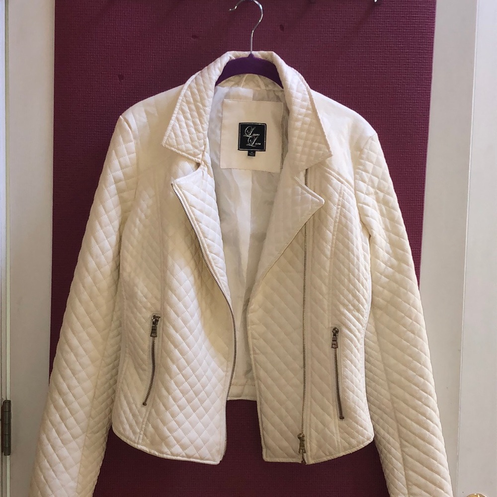 Faux leather jacket with pockets and zippers.